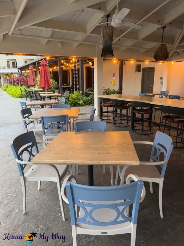 Tables and chairs by pool at Crooked Surf